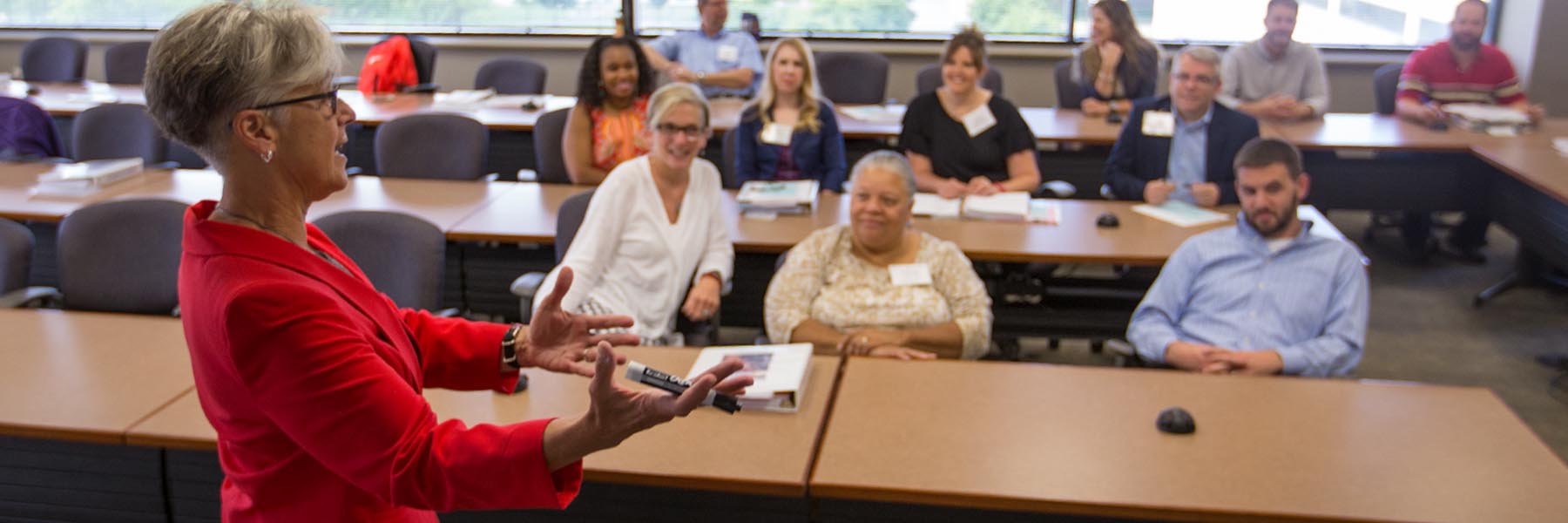 An executive education teacher speaks to a class.