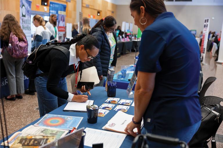 Student visiting a table at Nonprofit Expo
